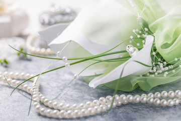 Wedding still life with pearl necklace and bouquet
