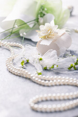 Wedding still life with pearl necklace and bouquet