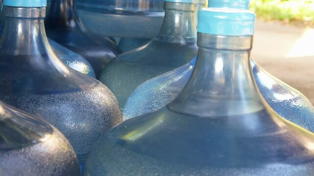 a male worker wipes a gallon using a cloth