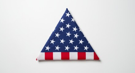 A neatly folded American flag displayed on a seamless white background.