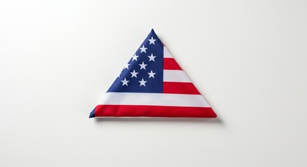 A neatly folded American flag displayed on a seamless white background.