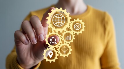 Person touching interconnected golden gears with business icons hand