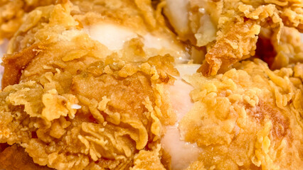 A close up showcasing crispy golden brown fried chicken with juicy white meat texture and visual