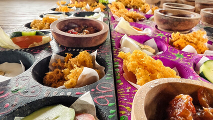 An artistic presentation of crispy chicken culinary delights featuring wooden bowls and vibrant...