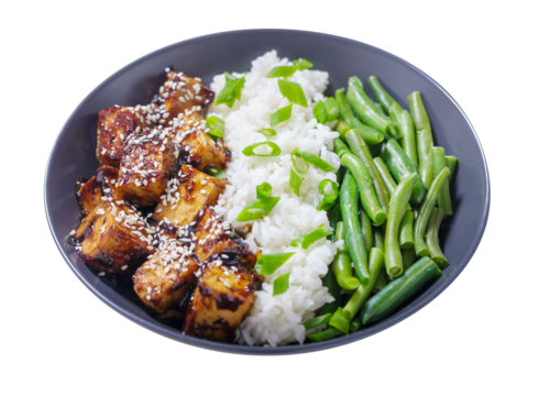 plate of fried tofu with sesame seeds, rice and green beans isolated on transparent background