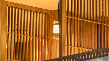 Serenity in timber: A harmonious interplay of light, shadows, and vertical wooden design elements