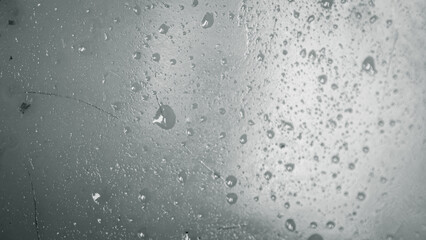 Silvered liquid surface displaying droplets and subtle imperfections texture backdrop