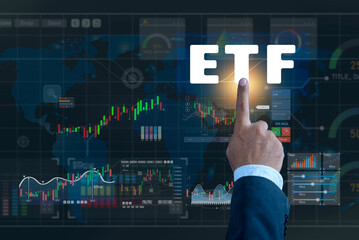 Businessman pointing at ETF (Exchange Traded Funds) on a virtual screen, ETF Exchange traded fund Investment finance concept. Business and Technology Concept. Growing Wealth in the Financial Market.