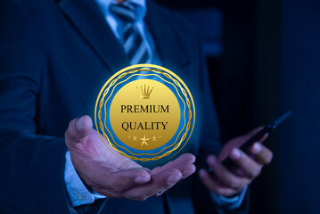 Hand shows the sign of the Luxury premium golden badge labels. premium quality, Guarantee, Standards, ISO certification and standardization concept, satisfaction, service experience.