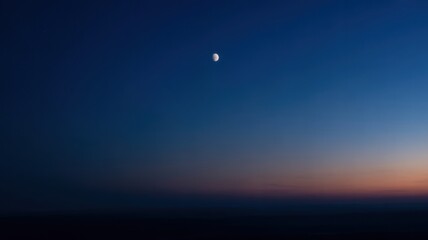 Serene evening sky with half moon at dusk