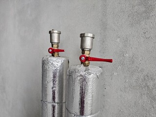 Industrial gas cylinders with safety valves displayed against a concrete wall concept