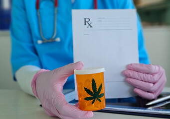 Prescription for medical Marijuana handed by doctor to patient with cannabis leaf