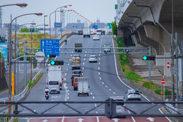 A cityscape of traffic jam at the city street under the overpass telephoto shot