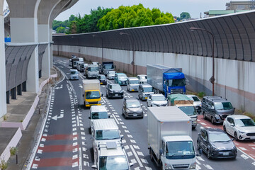 A cityscape of traffic jam at the city street under the overpass