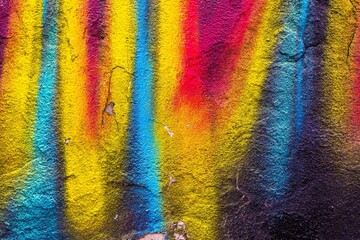 Vibrant neon colors in street art texture featuring yellow, blue, red. Retro 80s, urban style, bold...