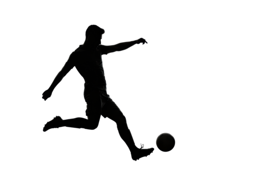 Isolated Silhouette of a Soccer Player Kicking the Ball
