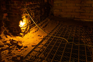 a burning lamp in a brick basement
