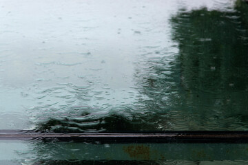flowing rain water on the window glass