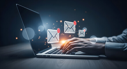 Person typing on laptop with glowing email icons and notification badges, indicating active communication or urgent messages in a digital workspace