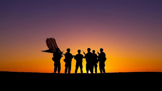 Soldiers raising flag at sunset silhouette