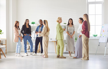 Full length photo of a group of diverse female business people chatting after meeting. Company...
