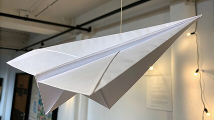 Paper airplane hanging indoors, creativity and children's imagination