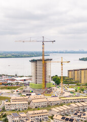 Construction cranes building towers near Marina Muiderzand in Almere