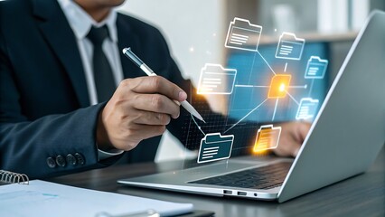 Businessman using laptop with glowing digital network of folders and data
