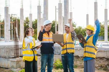 An elderly male engineer, a middle-aged man,two young Asian women work together on a construction...