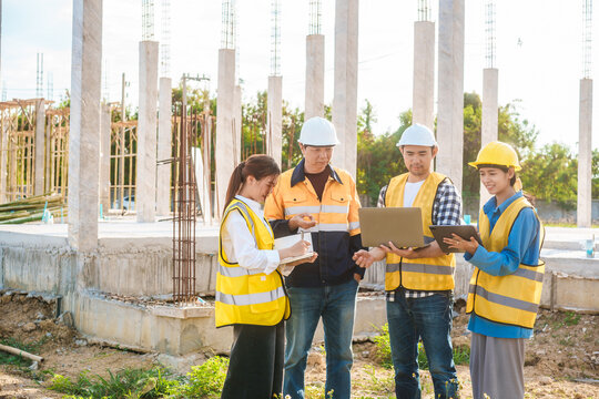 An elderly male engineer, a middle-aged man,two young Asian women work together on a construction site, reviewing plans,supervising workers, and checking the structural integrity accuracy of designs
