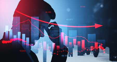 Stressed businessman silhouette with declining stock market char