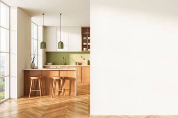 Modern kitchen interior with wooden elements and green backsplash adjacent to blank wall for poster...