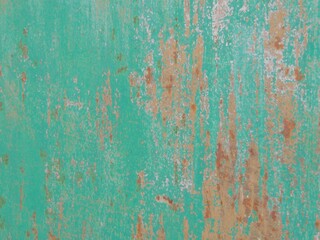 rusty textured surface of painted metal fence with scratches and peeling paint, rough texture of iron sheet with traces of former painting and rusting process