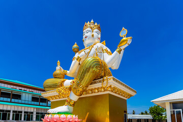 Big statue of god in Hinduism or Great Brahma sit on the base with sky background at Wat Saman...