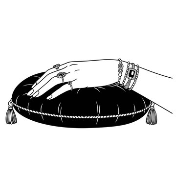 hand with rings on black pillow clip art preview