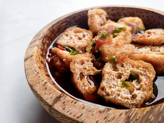 Tahu Gejrot (Indonesian food) consists of tofu that has been fried and then cut into small pieces and then eaten with a sauce with chili, garlic, shallots, sugar. Usually served in small