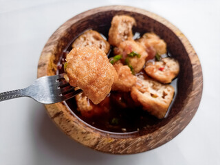Tahu Gejrot (Indonesian food) consists of tofu that has been fried and then cut into small pieces and then eaten with a sauce with chili, garlic, shallots, sugar. Usually served in small