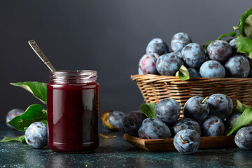 Ripe plums with jam on the kitchen table.