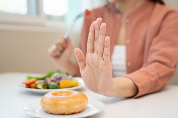 Diet food loss weight concept, Hand of woman pushing sweet away and avoid to sugar to control...