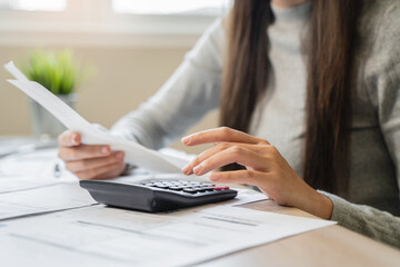 Financial owe, hand of asian woman sitting, holding credit card, stressed by calculate expense from invoice or bill, no money to pay, mortgage or loan