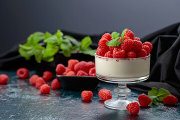 Mascarpone cream with fresh raspberries in a clear bowl.