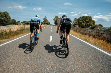 Two people ride a bike and sprint for victory on a racing bike