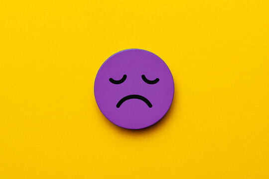 Tired cartoon face with an exhausted expression in purple on a soft pink background, ideal for illustrating workplace burnout, low employee morale, or business stress visuals for presentations.