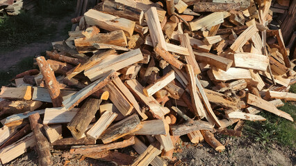 Heap firewood stack, natural wood. Cut firewood top view. Stock of firewood for heating house.