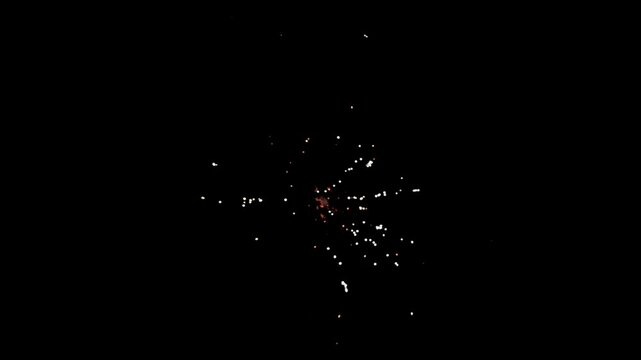 Colorful holiday fireworks bursting in the night sky during a festive celebration