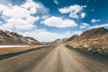 Ideal gravel road in the highlands, mountainous natural landscape.