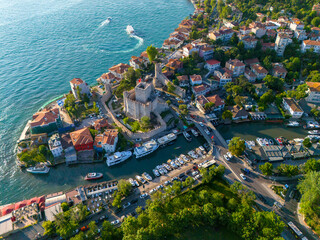 Anatolian Fortress Stunning Aerial View of a Coastal Town with Boats and a Bridge. High-angle, full shot of picturesque coastal town nestled beside waterway. Anadolu Hisari Bosphorus Istanbul Turkey