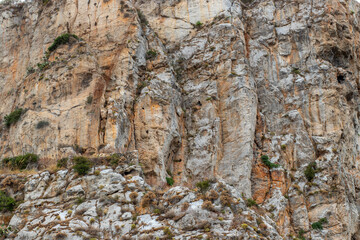 Cefalu Rock, a cliff in Sicily, Italy. Texture of sedimentary rock layers, a close-up view.