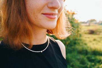 Minimalist Beaded Necklace with Heart Pendant on Woman's Neck