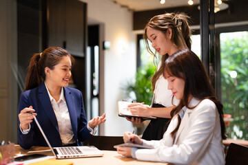 Focused female intern listening to senior  business woman mentor teacher explaining online strategy...